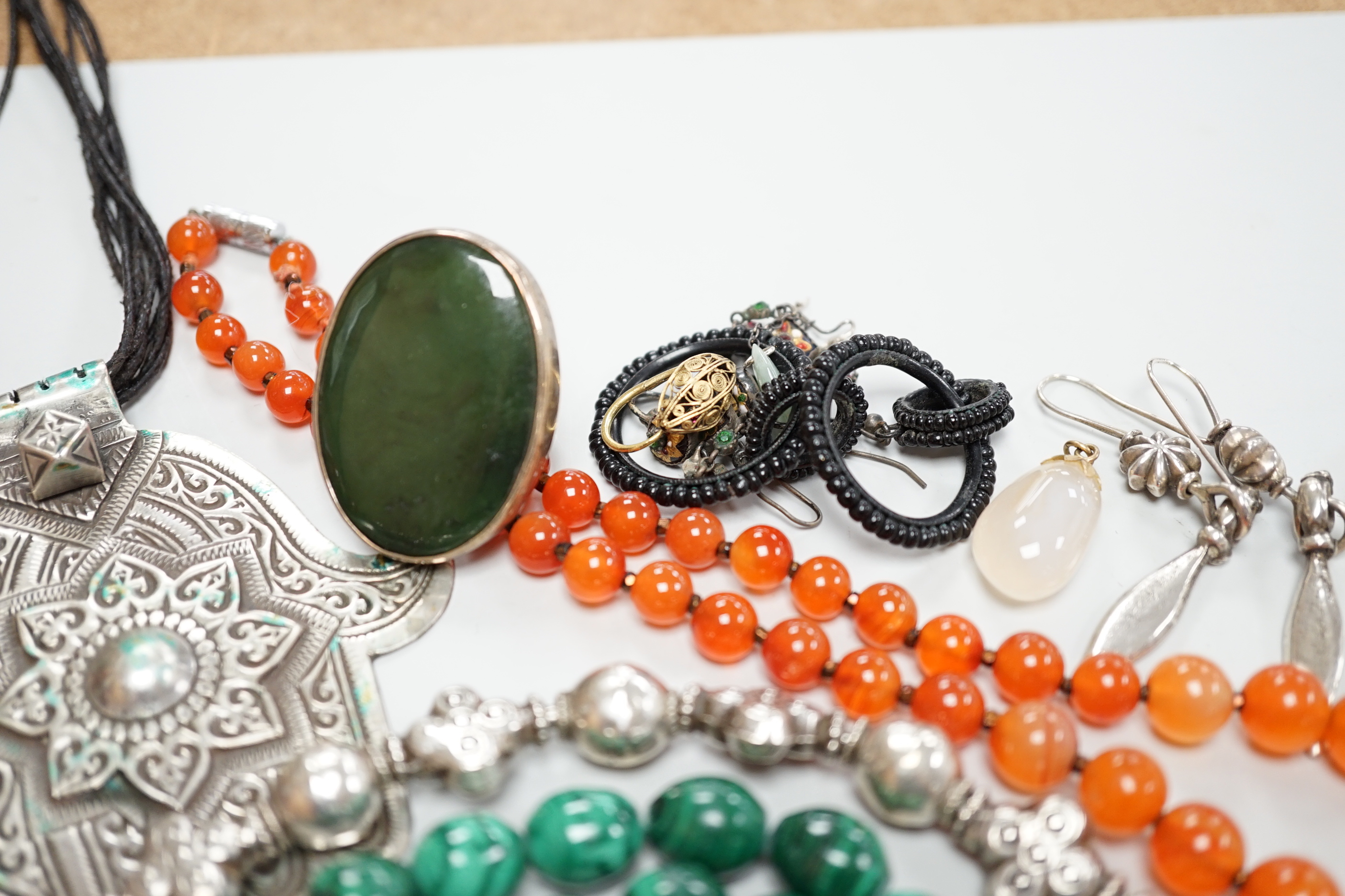Assorted jewellery including a South American? white metal fringe necklace, a malachite bead necklace, amber earrings, filigree earrings, jet earrings, Hand Of Fatma pendant, agate bead necklace, hardstone pebble necklac